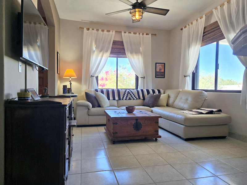 Casa j9 downstairs living room surrounded by colorful landscaping